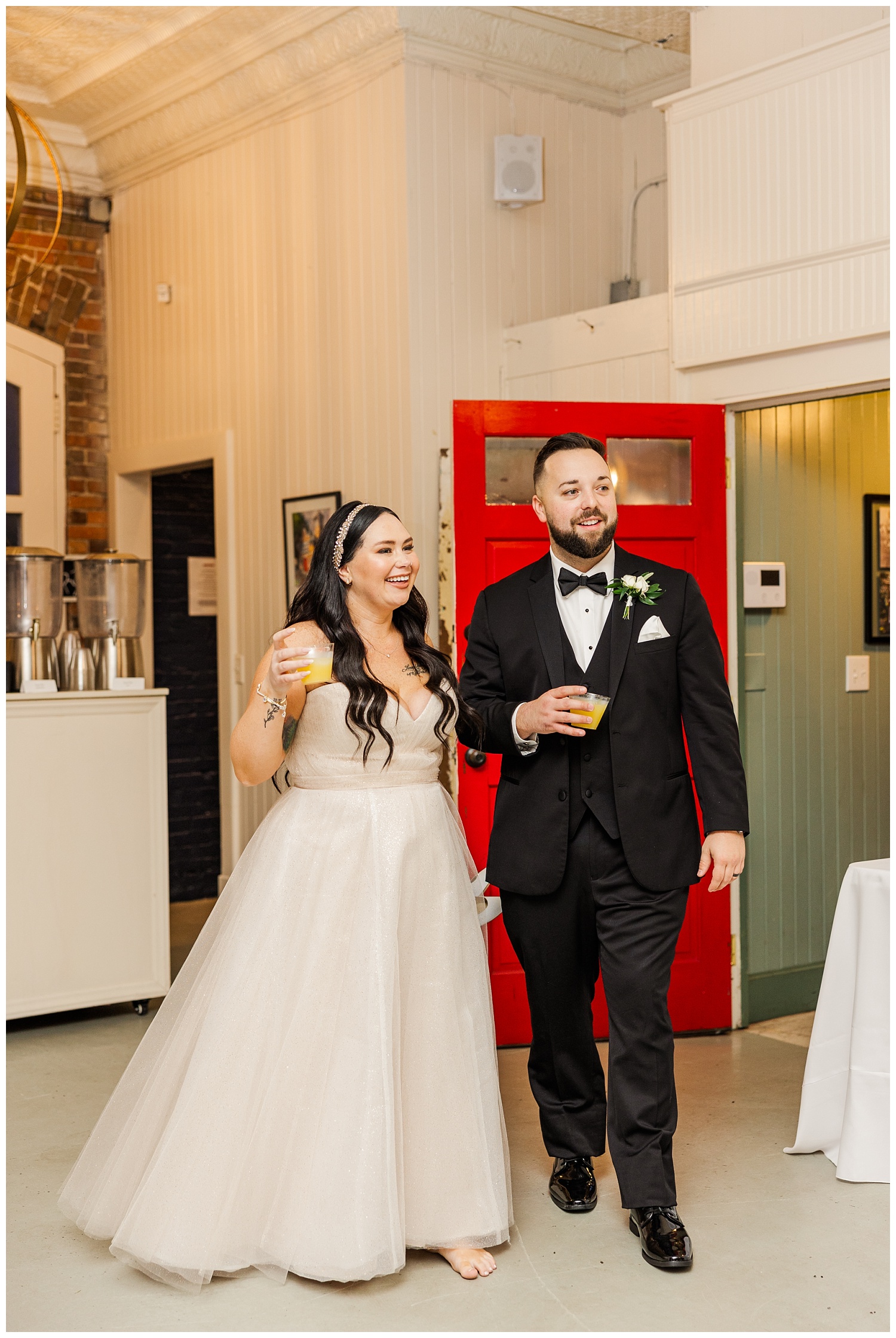 bride and groom holding drinks at cocktail hour at downtown Wilmington venue