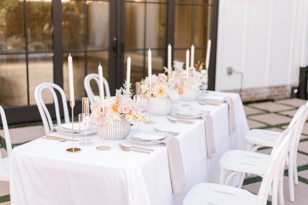 reception details with peach and pink flowers and candles