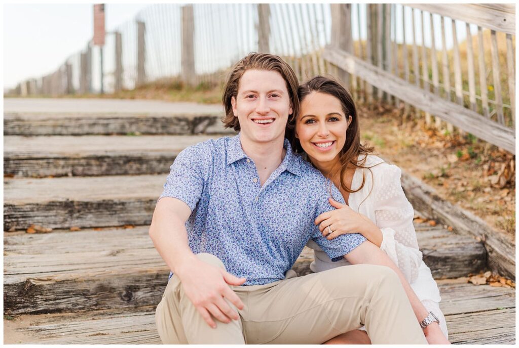 couple sitting on stairs at Kure Beach spring engagement session