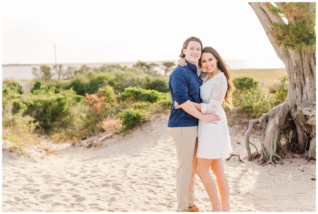 couple posing for spring engagement photos at Fort Fisher