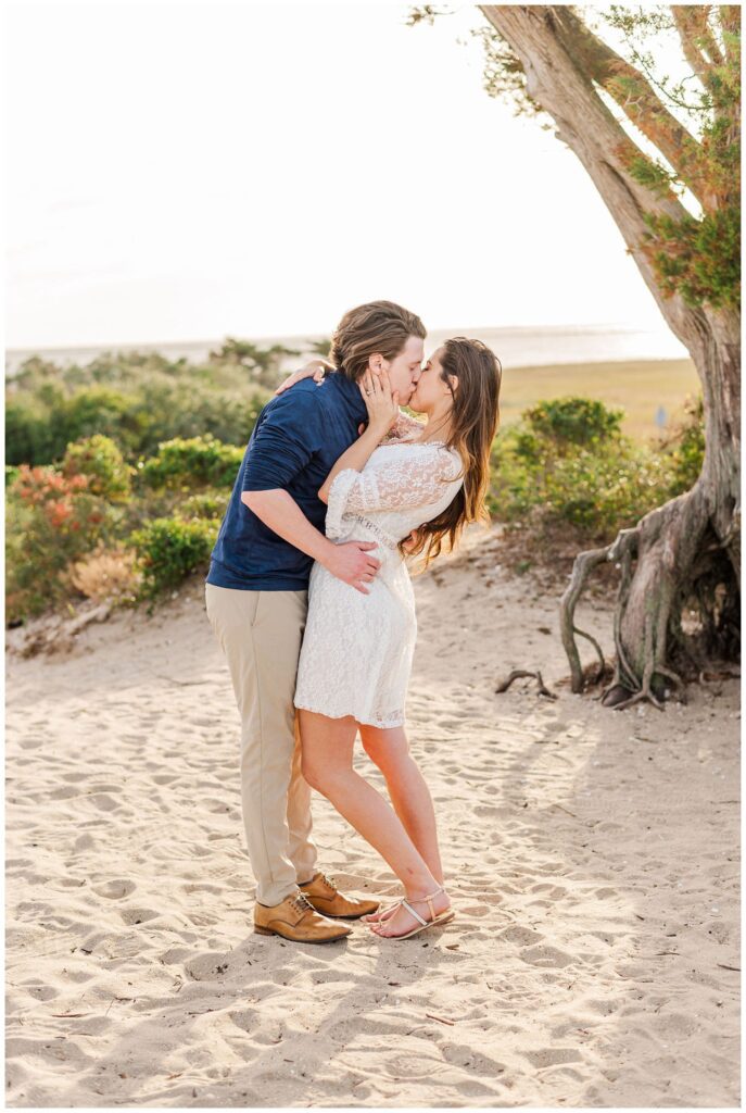 couple kissing at Fort Fisher beach engagement session