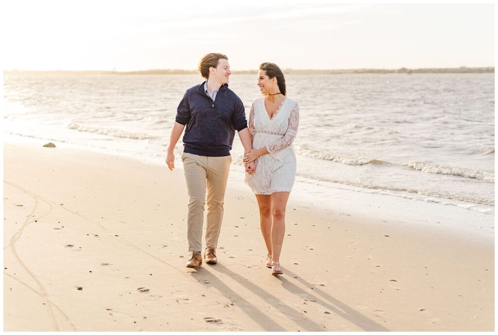 couple walking on the beach at Fort Fisher engagement session