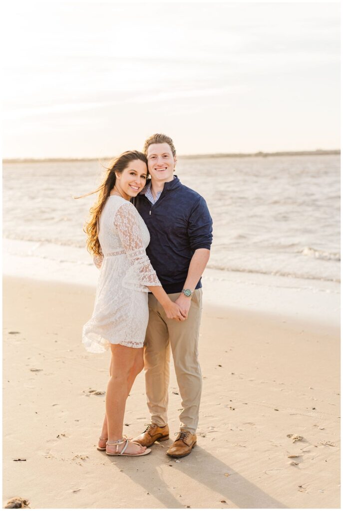 couple touching foreheads on the beach at Fort Fisher engagement session