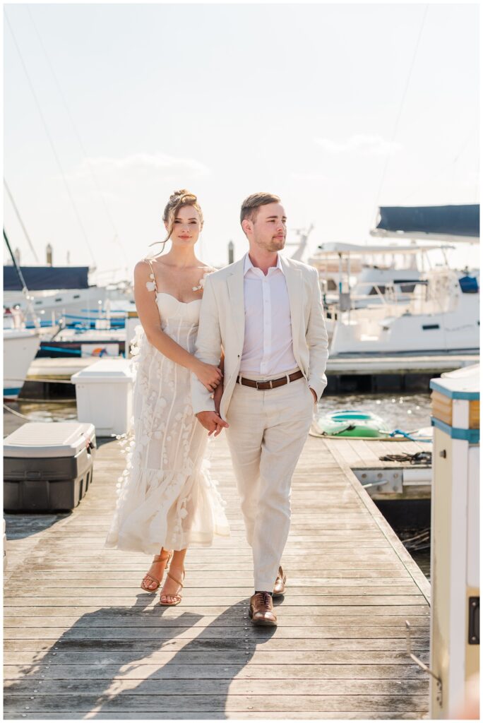 elopement couple walking on the dock at Charleston Harbor