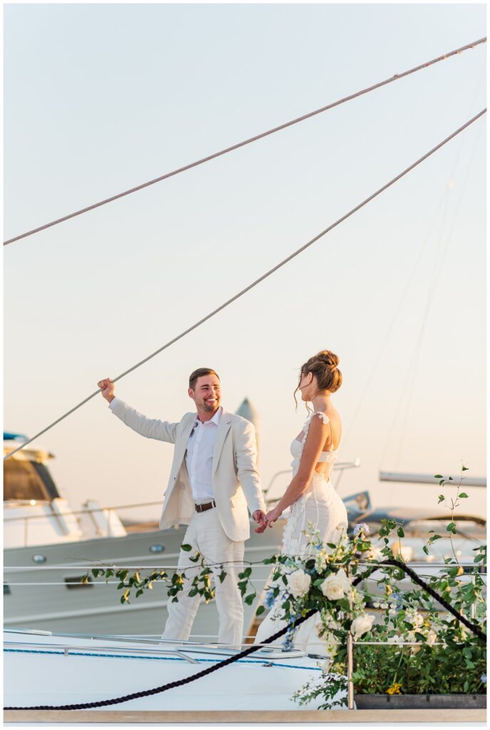 elopement couple walking on a sailboat in Charleston