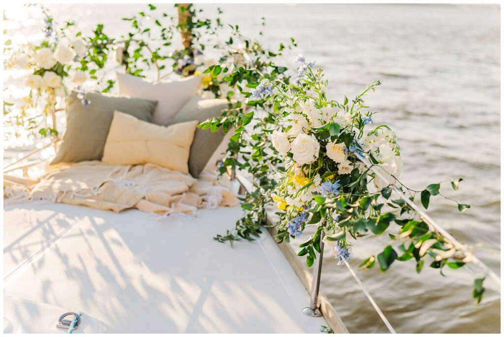 pillows, blankets and flowers at the front of a sailboat in Charleston