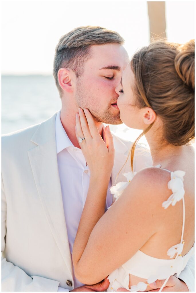 couple kissing on a boat in Charleston Harbor