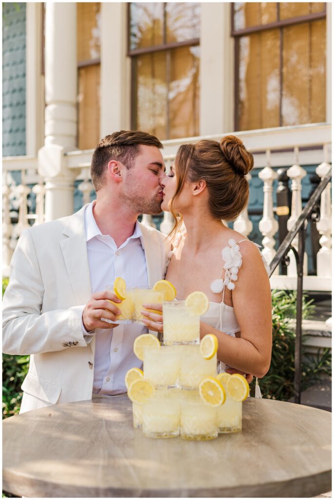couple kissing at elopement reception cocktail hour in Charleston