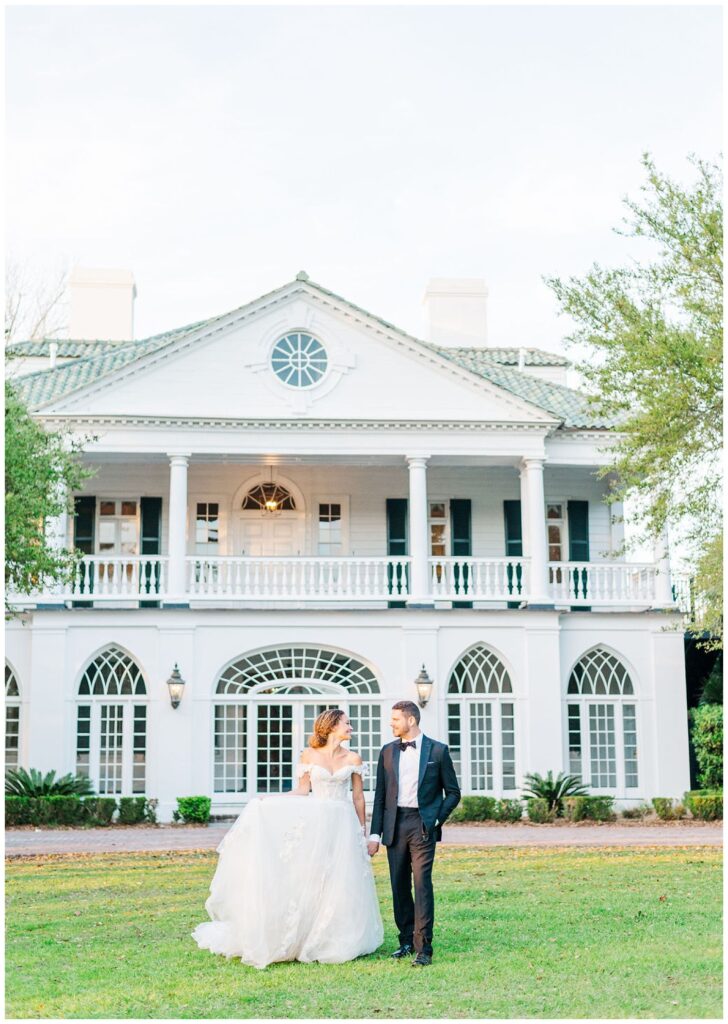 bride and groom walking on the front lawn at Charleston, SC venue