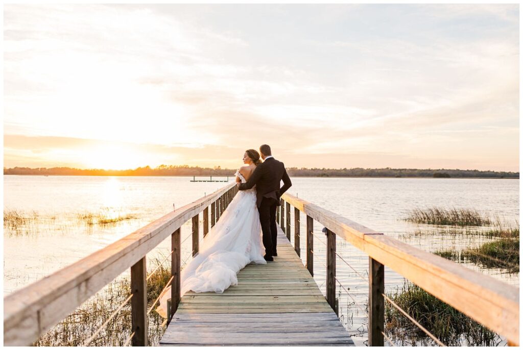 bride and groom posing on the dock at Lowndes Grove