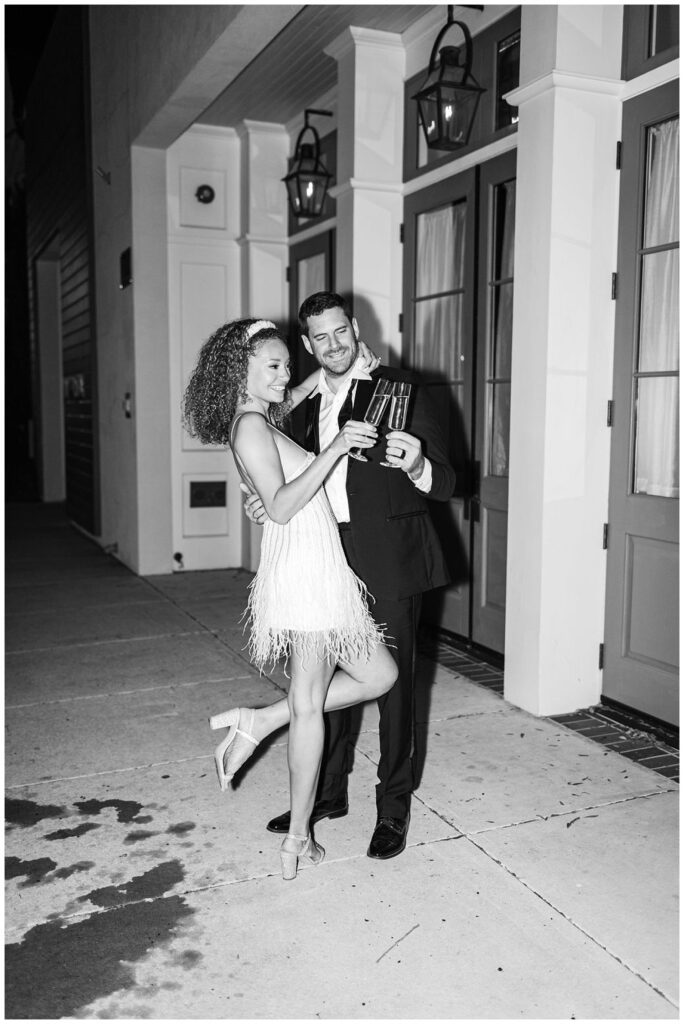 wedding couple toasting champagne at night at Charleston styled shoot