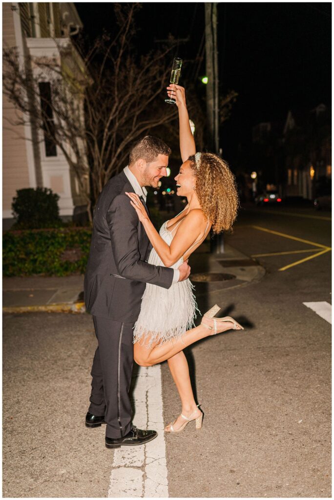 wedding couple drinking champagne at night at Charleston styled shoot