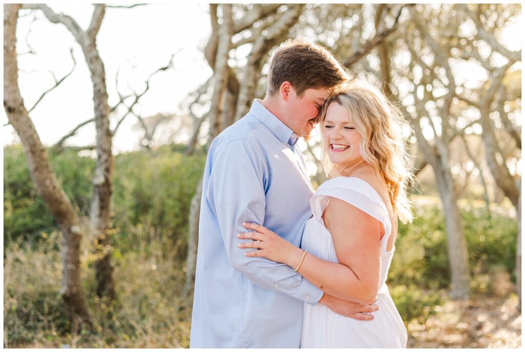 engaged couple laughing at the beach at Fort Fisher