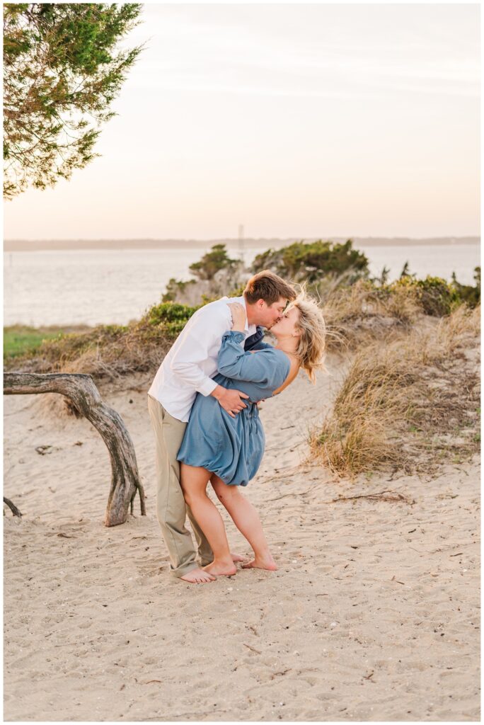 engaged couple kissing on the beach at Fort fisher