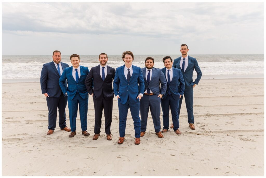 groomsmen standing on the beach at Ocean /isle