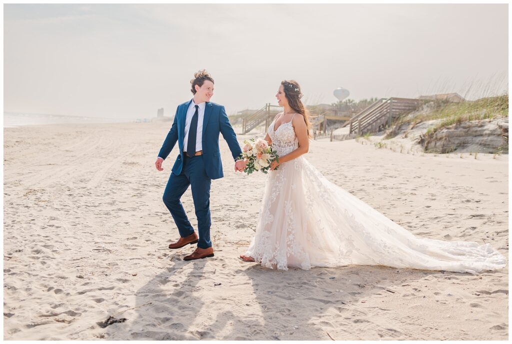 wedding couple walking on the beach in Ocean Isle