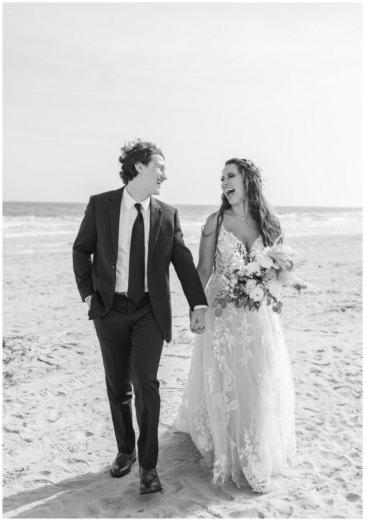 wedding couple walking and laughing on the beach in Ocean Isle