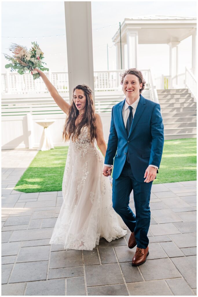 bride and groom walking in to wedding reception in North Carolina