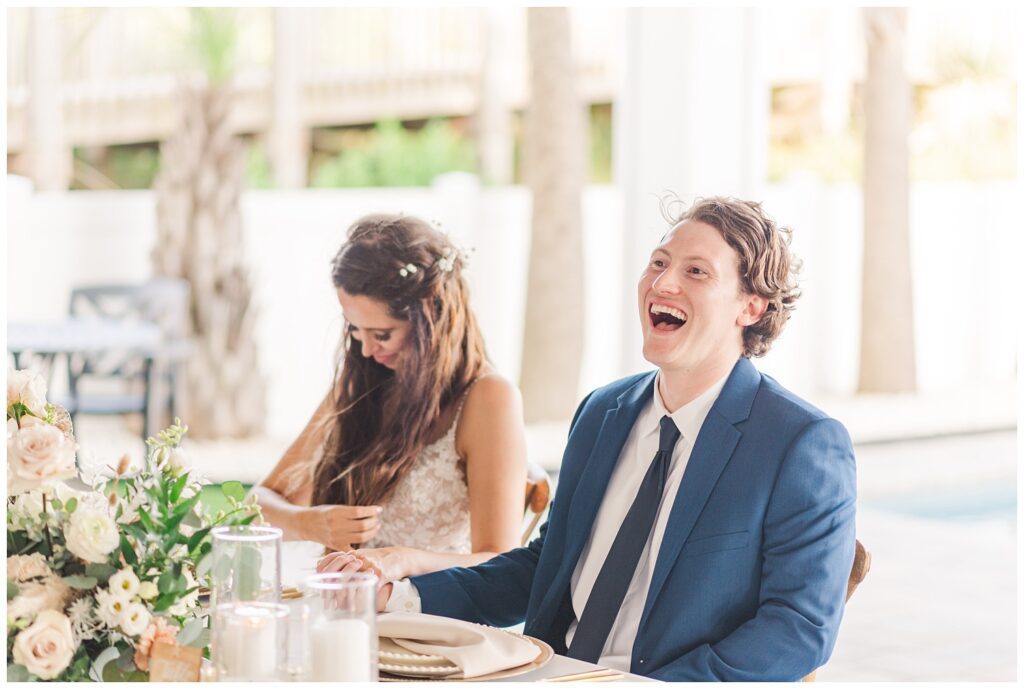 bride and groom laugh at wedding toast