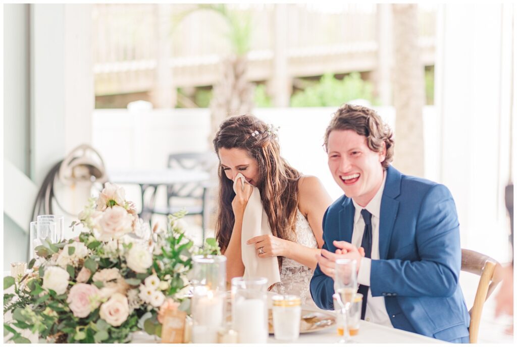 bride and groom laugh at wedding toast