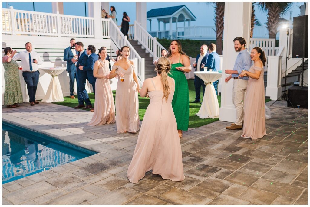 wedding guests dancing at beach reception in Ocean Isle