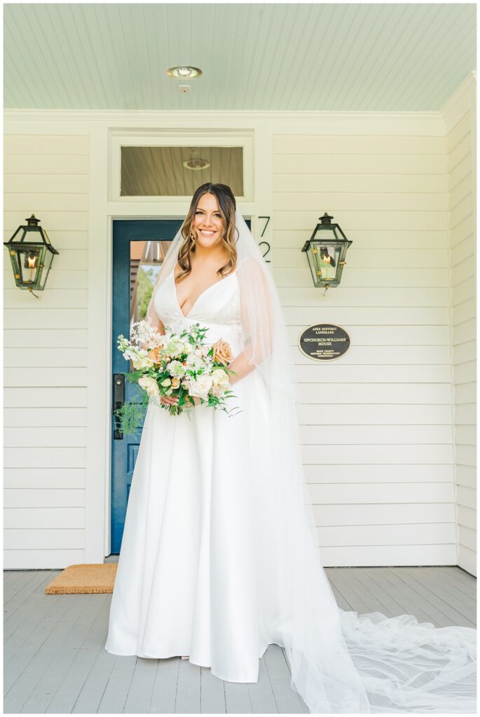 bride standing on the front porch at the Upchurch venue