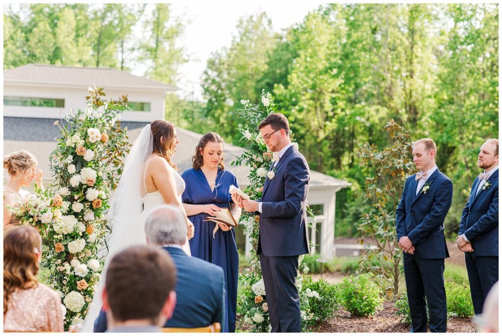 groom reading his vows at spring outdoor wedding in Apex, NC