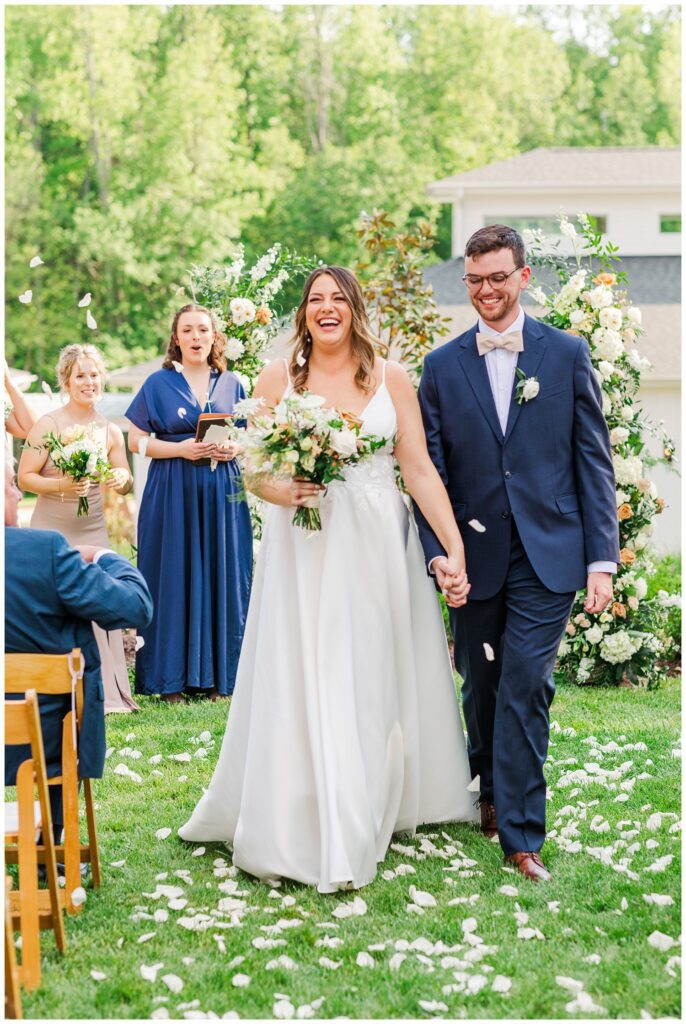 bride and groom laughing at spring wedding ceremony