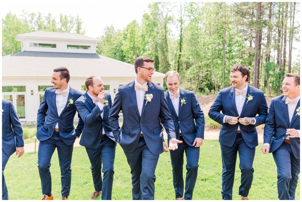 groomsmen posing on the front lawn at Upchurch wedding venue