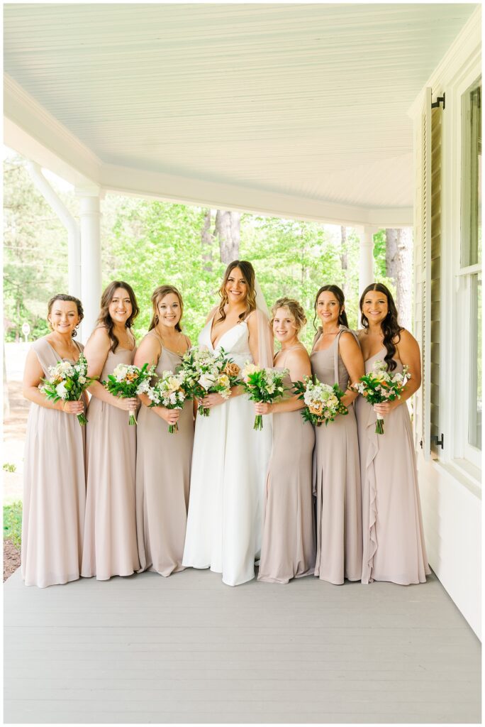 bride and girls posing on the front porch at North Carolina wedding venue