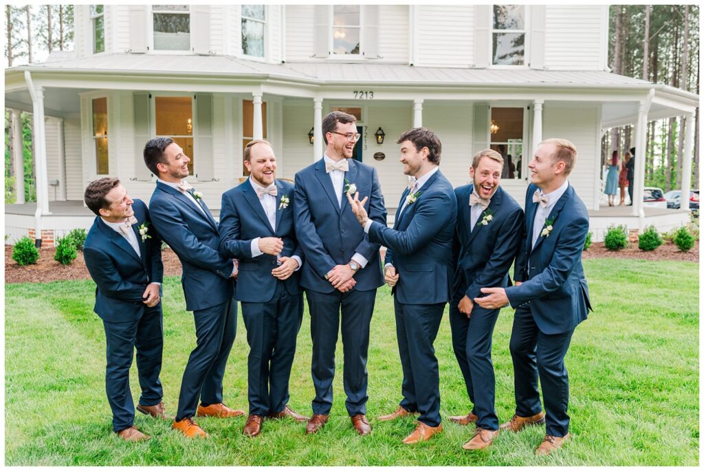 groomsmen laughing on the front lawn at the Upchurch venue