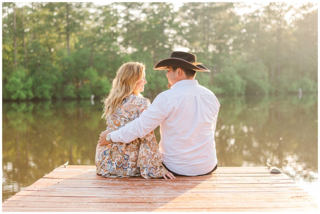 couple sitting on a dock during golden hour in Fayetteville, NC