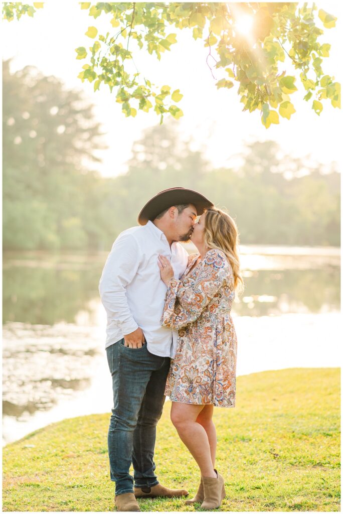 engaged couple kissing under a tree at Fayetteville session