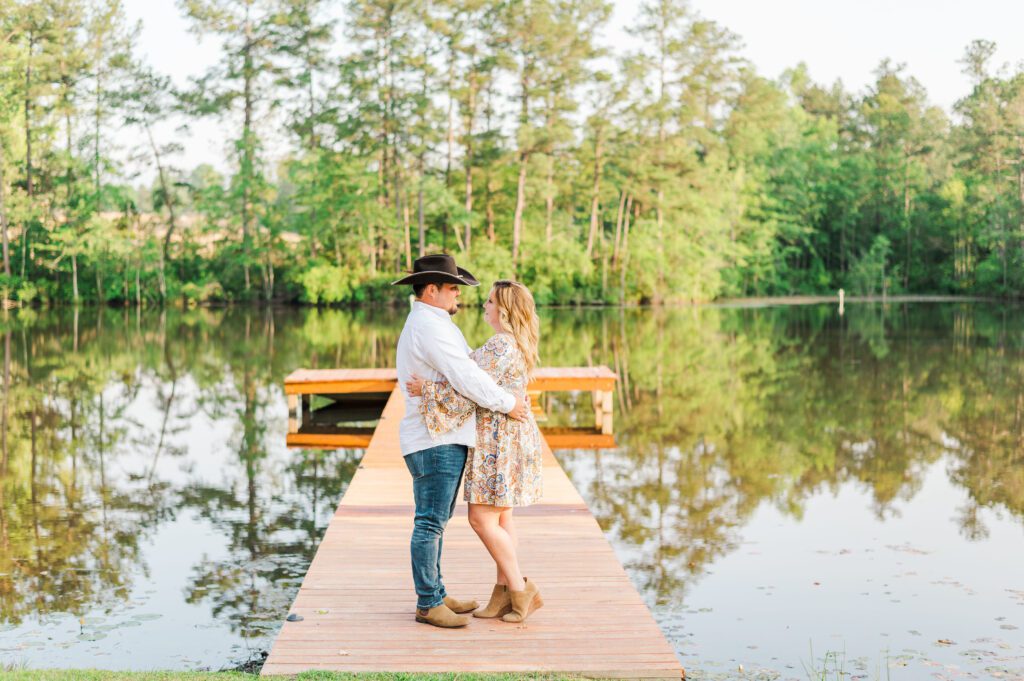 engaged couple standing on a dock in Fayetteville