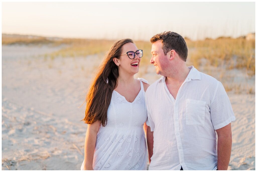 couple laughing at sunset in Wrightsville Beach, NC