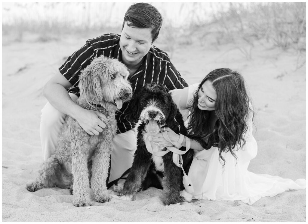 Wilmington engagement photographer on the beach with two dogs and their owners