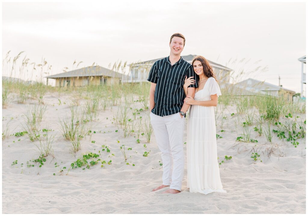 engagement couple standing on the beach in Wilmington