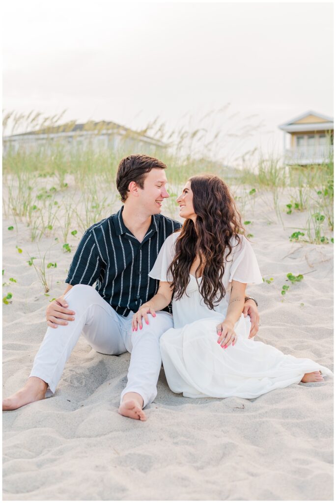 couple sitting together on the beach in Wilmington
