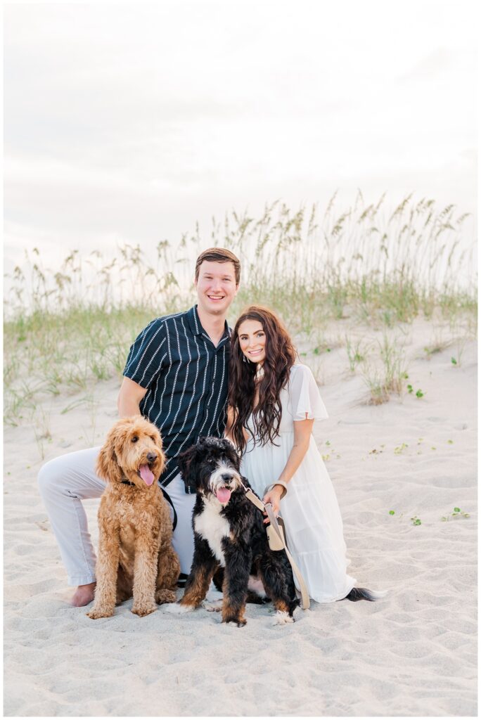 couple posing with their two dogs at summer shoot in Wilmington