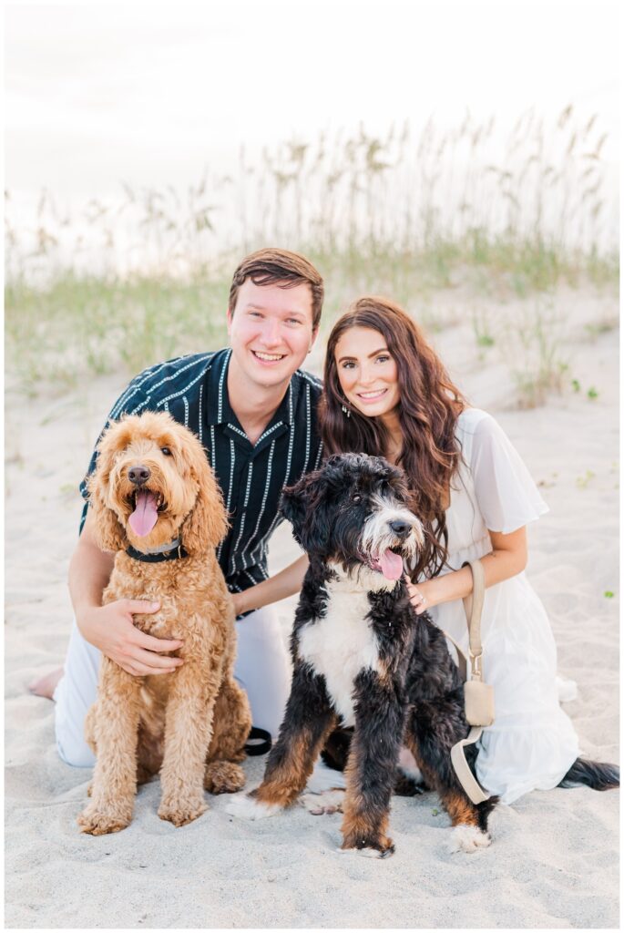 two dogs sitting with their owners for a North Carolina engagement session