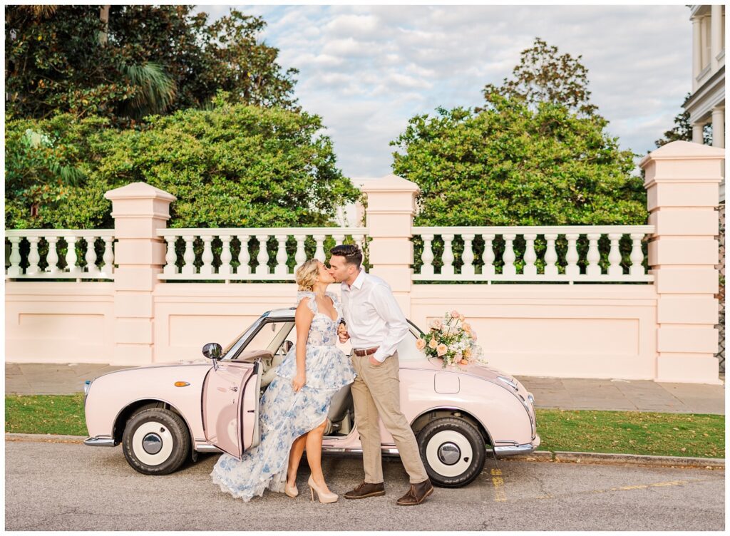 couple kissing in front of the Pink Figgy car in Charleston