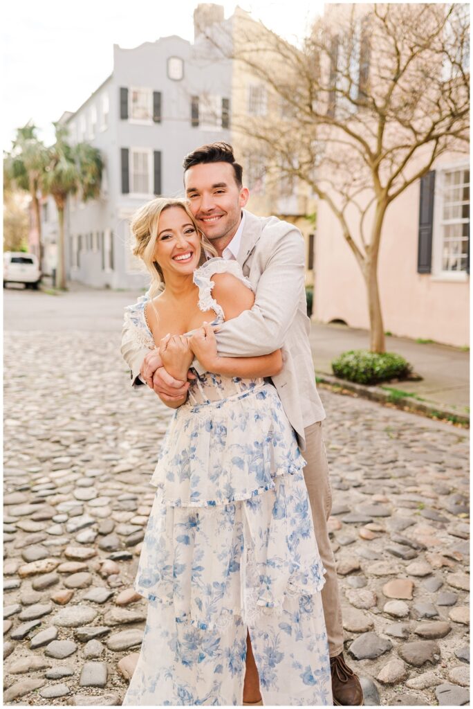 couple hugging on a stone road in Charleston for engagement styled shoot