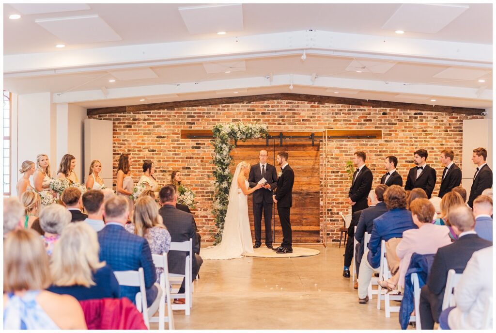 bride reading her vows at fall wedding ceremony at the Meadows Raleigh venue