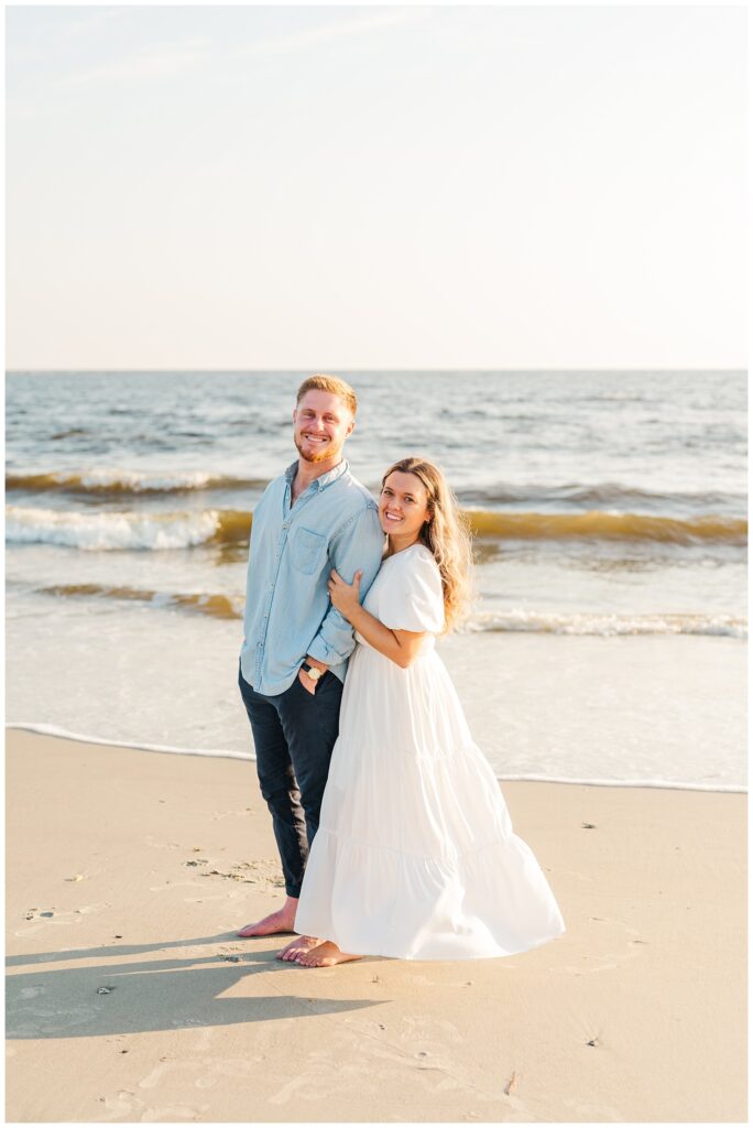 couple wearing blue and white outfits for North Carolina beach session