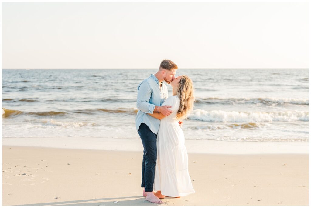 couple kissing on the beach in the summer on Oak Island, NC