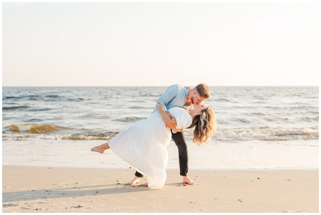 couple dipping back for kiss on the beach in Oak Island, NC