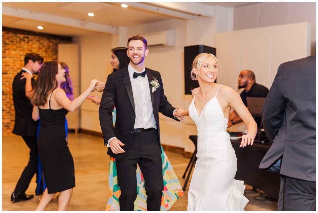 bride and groom dancing with guests at fall reception in Raleigh
