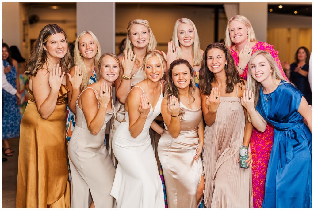 bride and her friends showing off their wedding rings at Raleigh reception