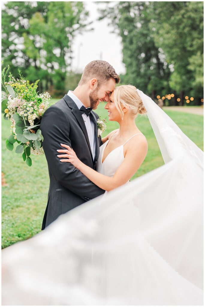 bride and groom touch foreheads at Raleigh wedding venue