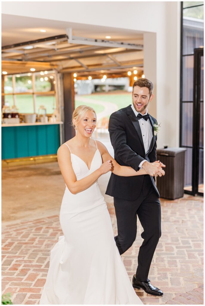 bride and groom make grand entrance into reception in Raleigh